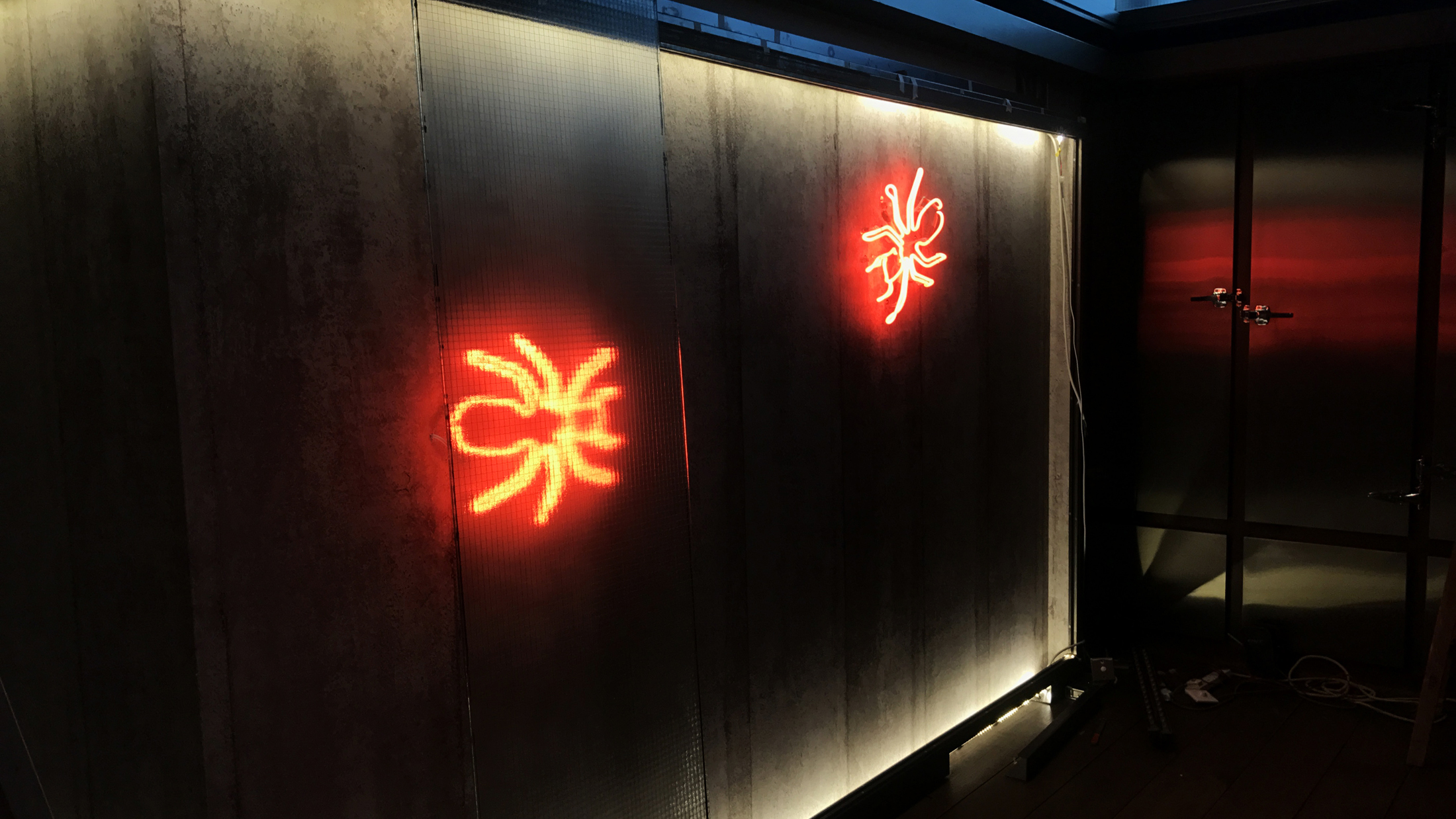 Close-up of neon tube and concrete wall installation