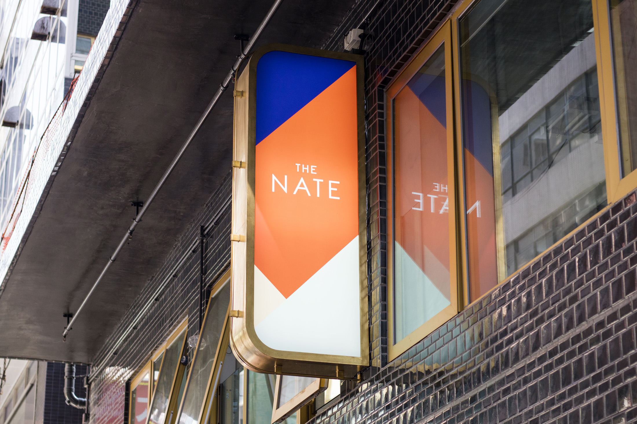 The Nate illuminated projecting sign fabricated by Sign First